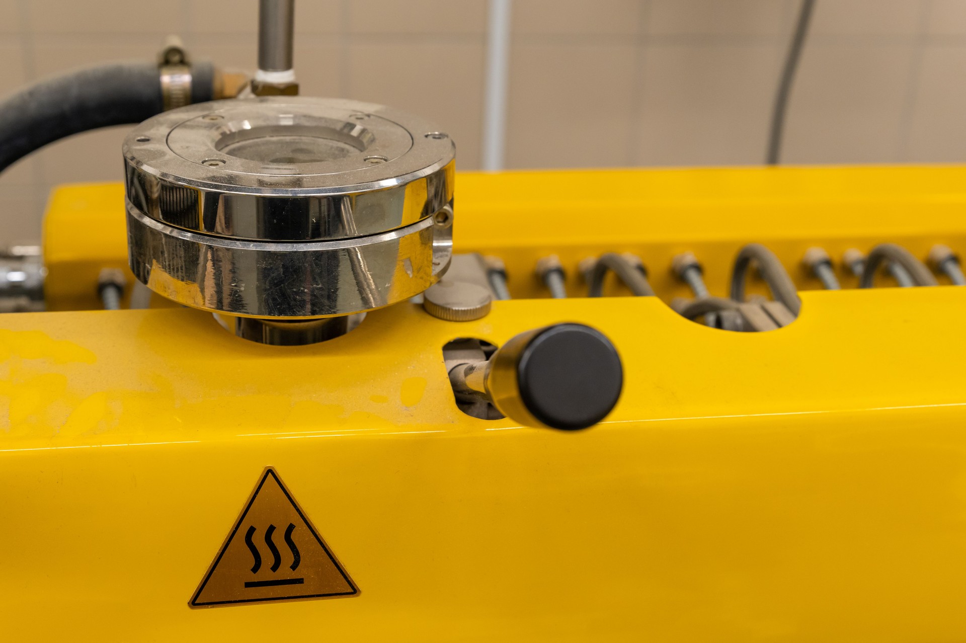 Industrial machine with a warning symbol and a control lever